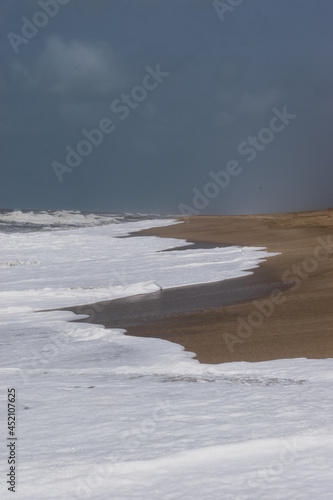 Arabian Ocean waves with foam of blue and turquoise color. Sea foam creating amazing shapes and patterns like glacier. Abstract Arabian Ocean blue water with white wave for background.