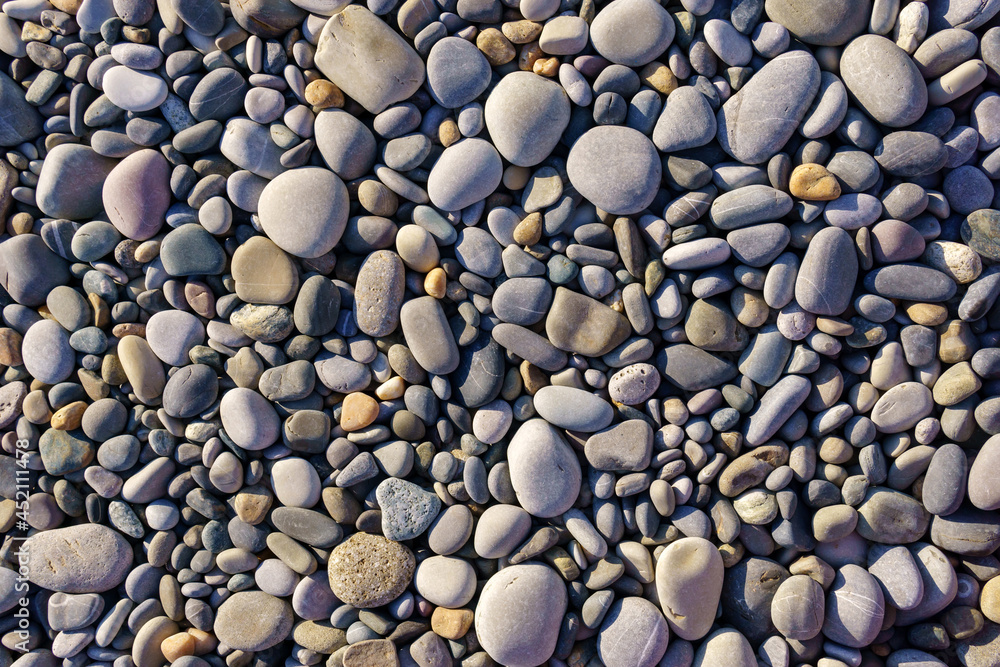 Small pebbles or stone in garden. Texture background. Round oval stones Small pebbles or stone in garden. Texture background. Round oval stones