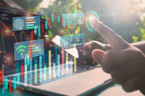 A man using smart phone and laptop for analyzing graph for data management to make report.Financial technology,Laptop ,many graphs.Investment.Photo concept of Data analyst and financial.