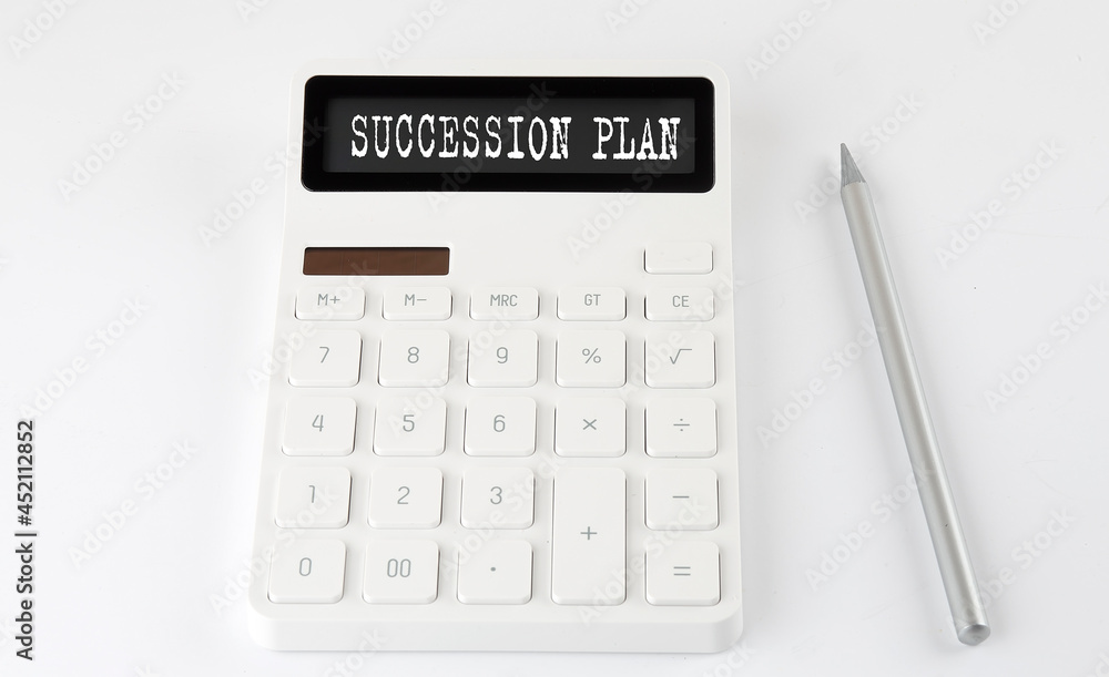 SUCCESSION PLAN business text on the calculator with pencil SUCCESSION PLAN business text on the calculator with pencil