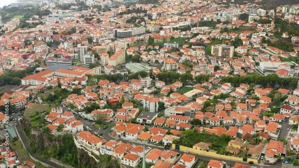 Madeira Islands, Portugal. Idyllic holiday destination within the Atlantic Ocean. Aerial view of dense settlement with charming cottages on volcanic island. High quality 4k footage Madeira Islands, Portugal. Idyllic holiday destination within the Atlantic Ocean. Aerial view of dense settlement with charming cottages on volcanic island. High quality 4k footage