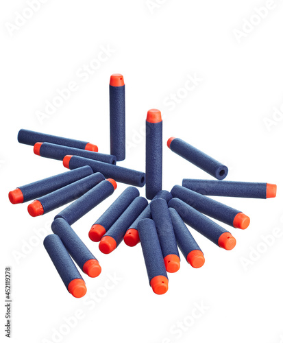 Scattering of toy plastic cartridges for air guns in blue with an orange tip, isolated on a white background.