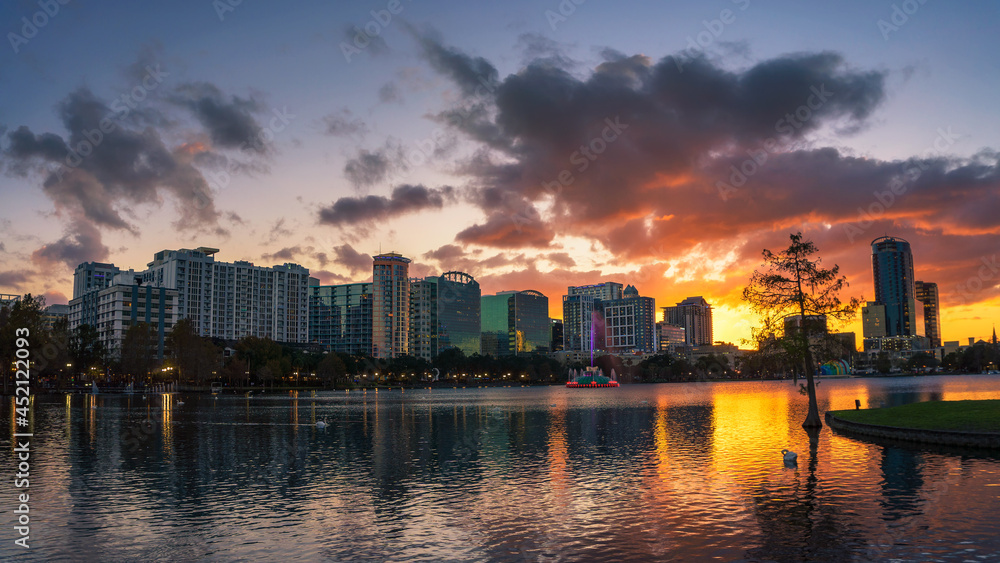 Colorful sunset above Lake Eola and city skyline in Orlando, Florida