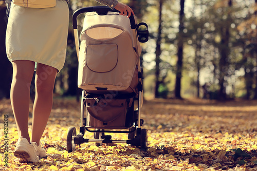 stroller view from the back legs, mom walk autumn abstract background fragment