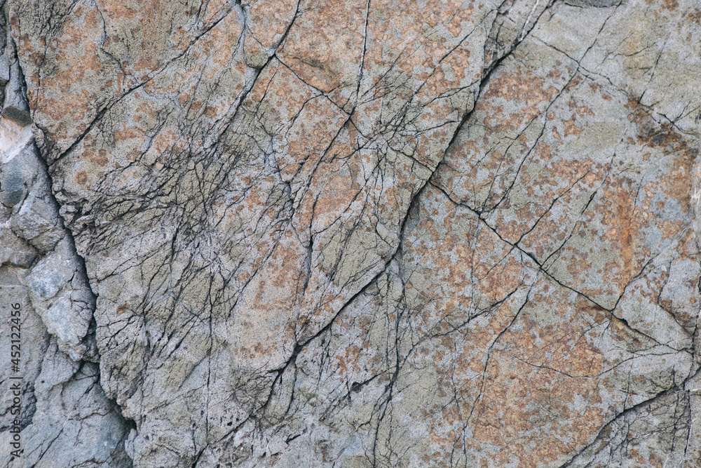 texture of a light gray stone with white and yellow-orange splashes. Texture mountain close up. Background for wallpaper on the phone, computer with the texture of a stone mountain texture of a light gray stone with white and yellow-orange splashes. Texture mountain close up. Background for wallpaper on the phone, computer with the texture of a stone mountain