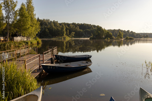 Early morning by the river. Landscape with boats at the pier.