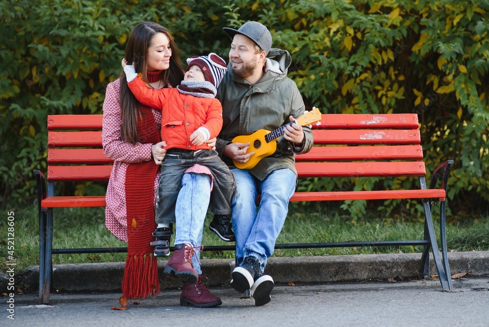 Young family walking in the park. Autumn. Young family walking in the park. Autumn.