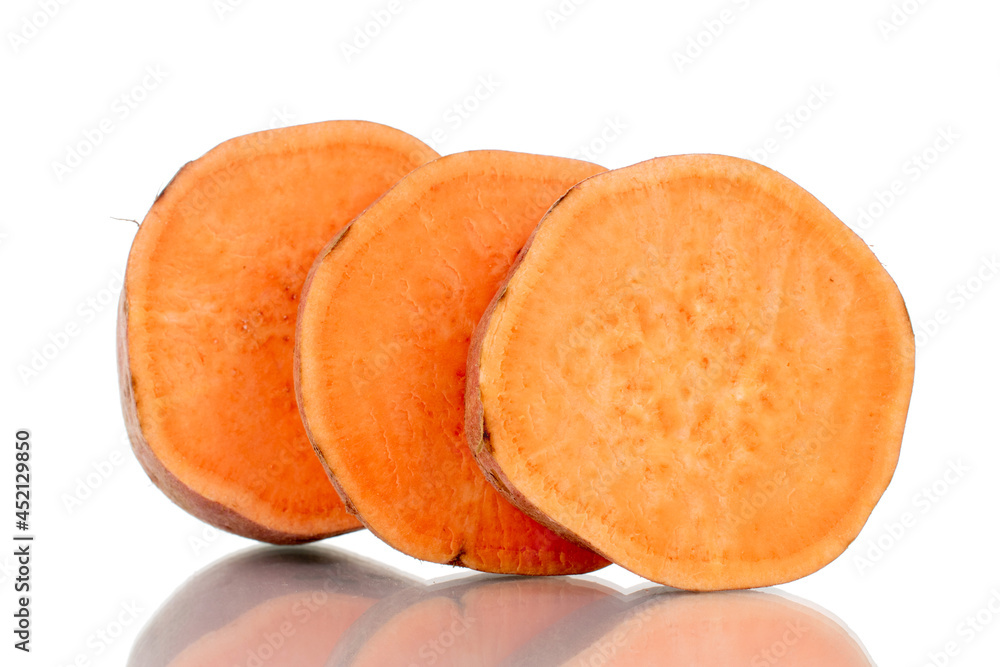 One whole fresh juicy sweet potato cut into several slices, close-up, isolated on white. One whole fresh juicy sweet potato cut into several slices, close-up, isolated on white.