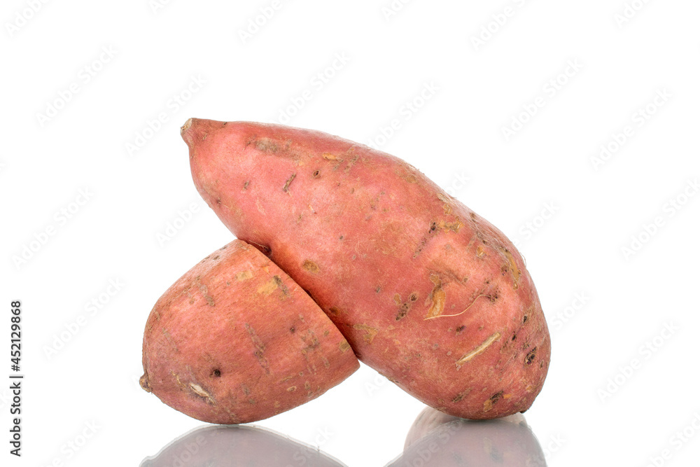 One whole and one half fresh juicy sweet potato, close-up, isolated on white. One whole and one half fresh juicy sweet potato, close-up, isolated on white.
