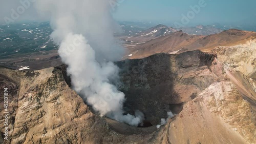 An amazing aerial shot with a drone in Kamchatka in 2021. Mutnovsky volcano, hot steam and sulfur coming out of the crater