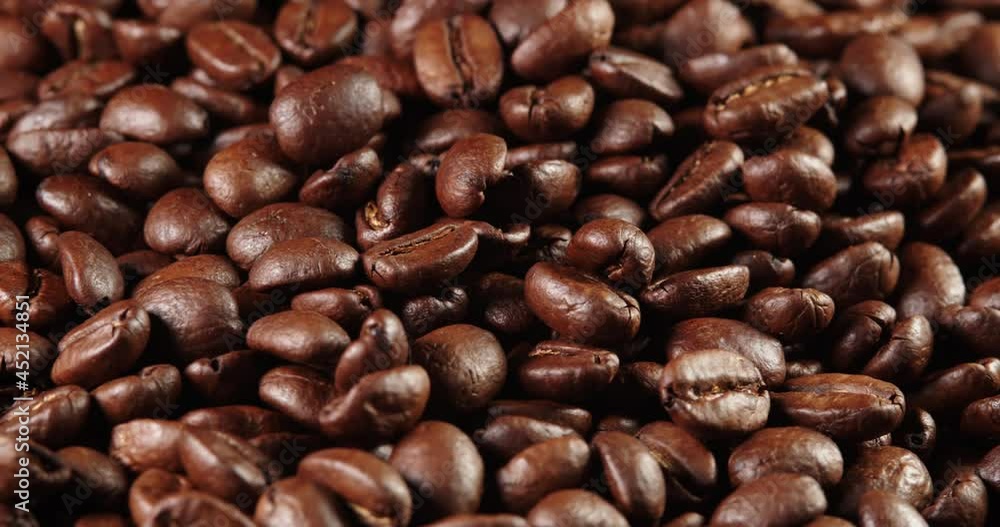 Roasted coffee bean. Fragrant coffee beans scrolls slowly around the camera. Slow Motion Close Up of Whole Roasted Coffee Beans. Roasted coffee bean. Fragrant coffee beans scrolls slowly around the camera. Slow Motion Close Up of Whole Roasted Coffee Beans.