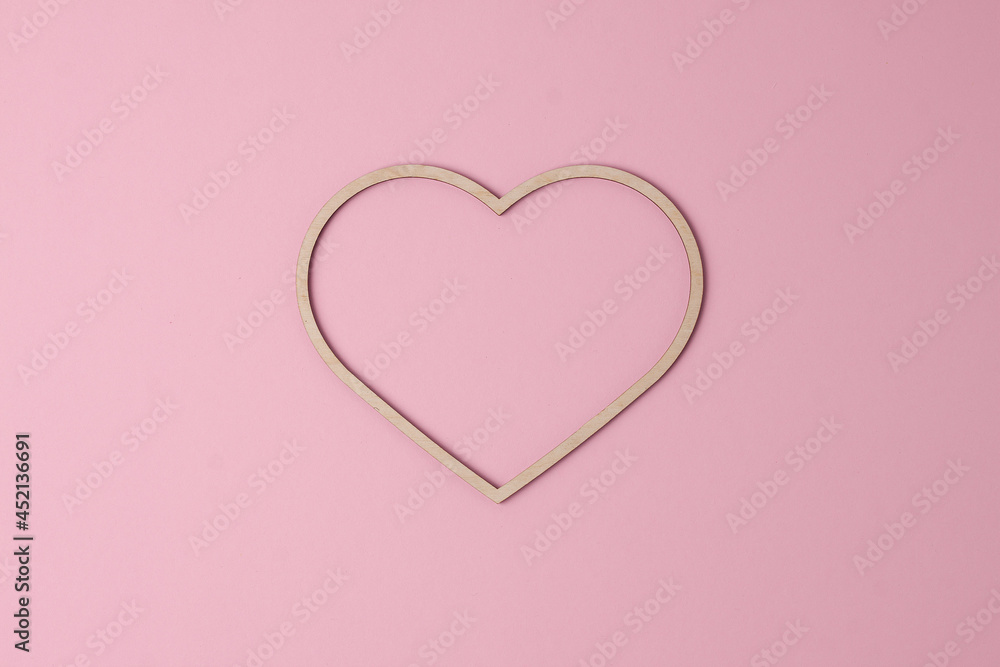 Cosmetic background with a wooden heart on pink. Flat lay, copy space Cosmetic background with a wooden heart on pink. Flat lay, copy space