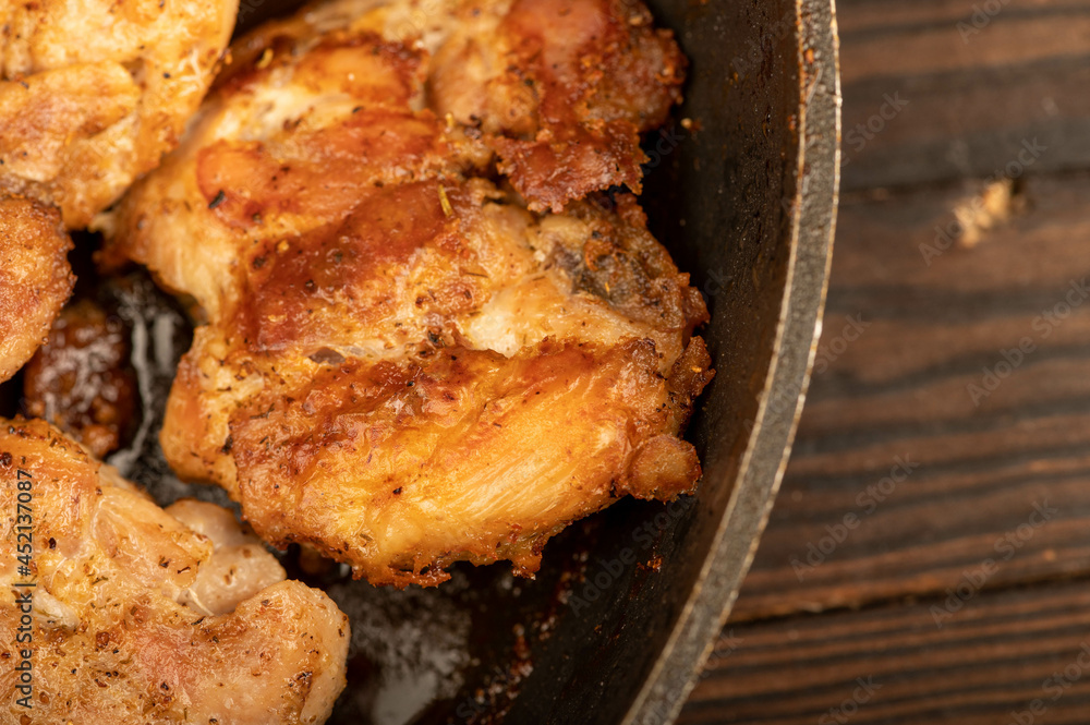 Fried pieces of meat in a frying pan, close-up, selective focus. Fried pieces of meat in a frying pan, close-up, selective focus.