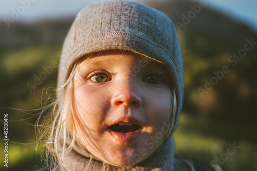 Child face close up cute baby wearing hat 2 years old kid traveling outdoor family vacations