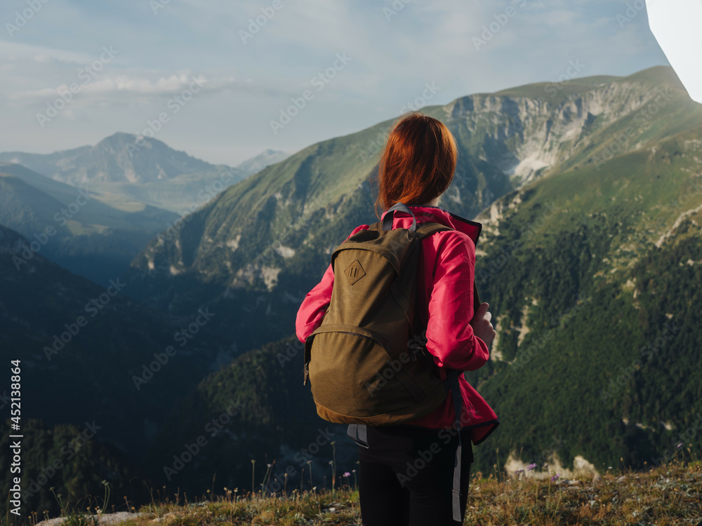 woman tourist with a backpack outdoors in the mountains fresh air woman tourist with a backpack outdoors in the mountains fresh air