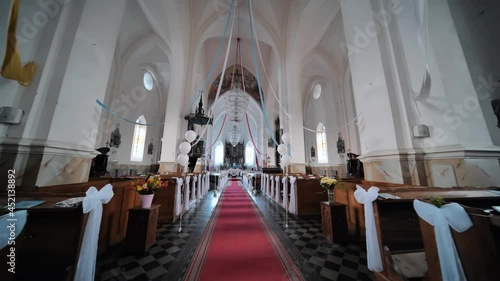 The interior of a Catholic church with white balloons before the church service. photo