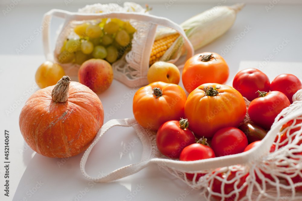 still life with vegetables and fruits and reusable net shopping bag for groceries still life with vegetables and fruits and reusable net shopping bag for groceries