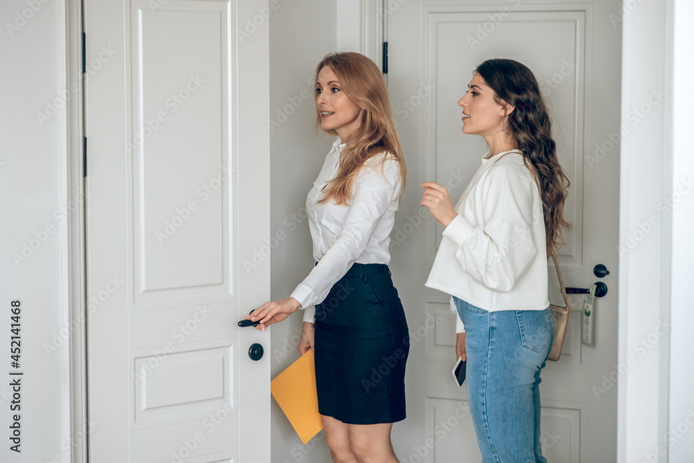 Real estate agent showing the apartment to a female customer Real estate agent showing the apartment to a female customer