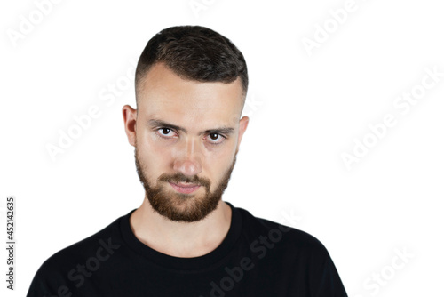 Portrait of a young man with a beard and mustache on a white background in a dark T-shirt, a man a little angry, he had a hard day at work and a headache from making serious decisions