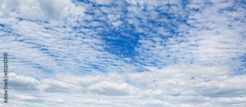 Panoramic landscape with blue sky and clouds.