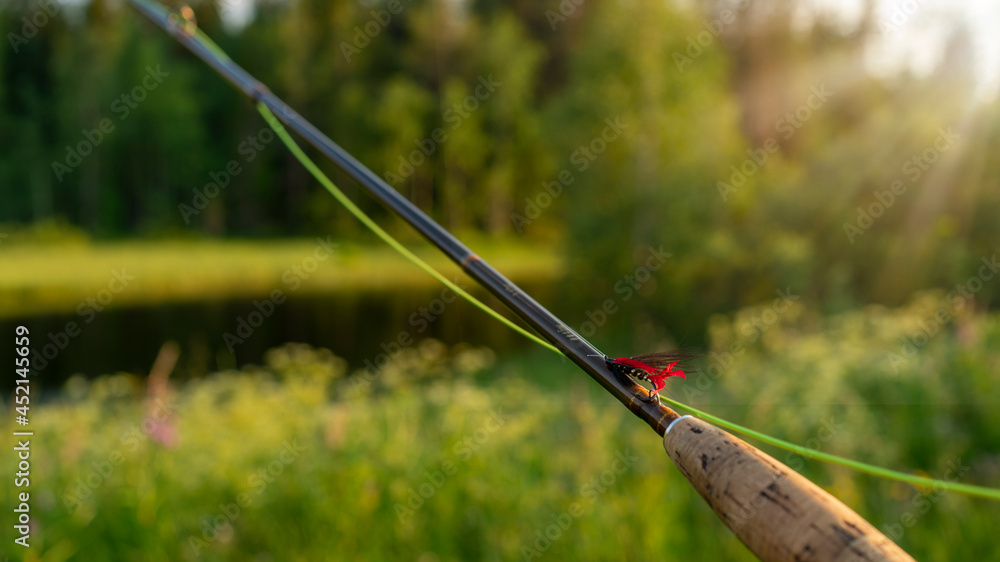 Fly fishing rod. Fishing on the mountain river. Summer Activities.