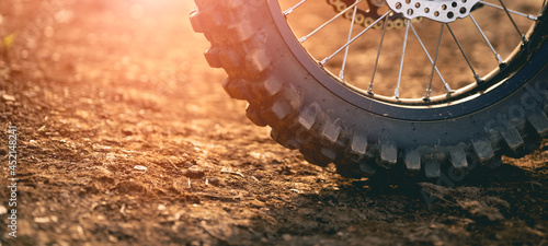 Konstfotografi Part of a dirt bike on a dirt road in a cornfield with warm light