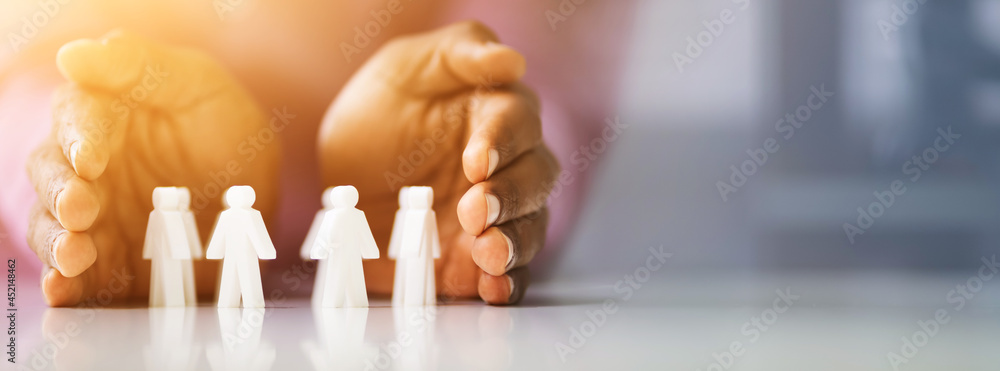 Fototapeta premium Person Protecting Multicolored Pawns
