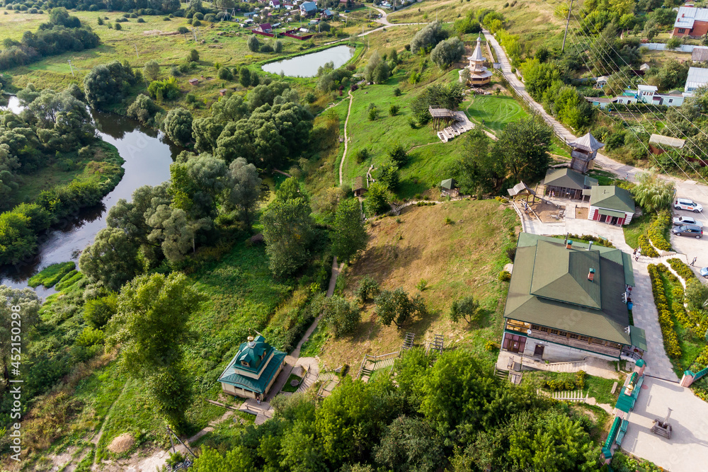 Tourist area around the temple in the old village of Rusinovo, panoramic aerial view, Ermolino town, Kaluzhskiy region, Russia - August 2021