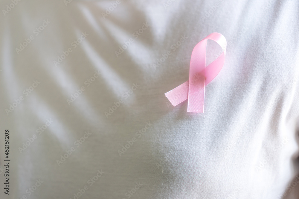 Breast cancer campaign with woman hold pink ribbon awareness for survivor. Medical healthcare background concept...