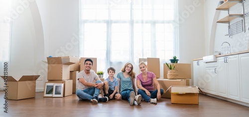 Fotografia Caucasian family father mother child packing cardboard box move to new house, apartment