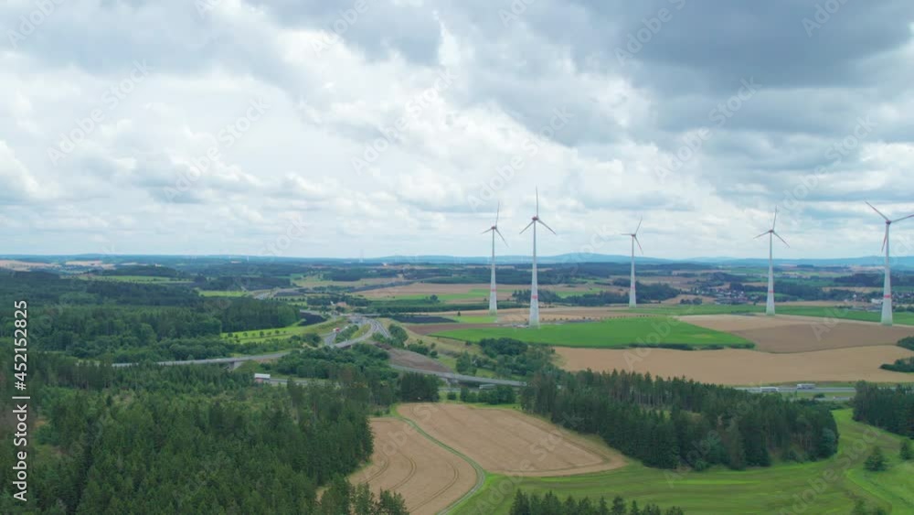 farm with wind turbines near the highway road interchange (aerial) farm with wind turbines near the highway road interchange (aerial)
