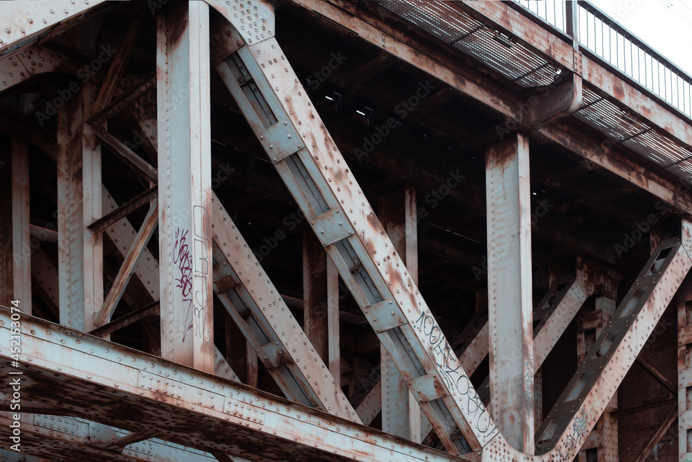 a fragment of a riveted structure with traces of rust on the steel span of the Prince Józef Poniatowski Bridge in Warsaw a fragment of a riveted structure with traces of rust on the steel span of the Prince Józef Poniatowski Bridge in Warsaw