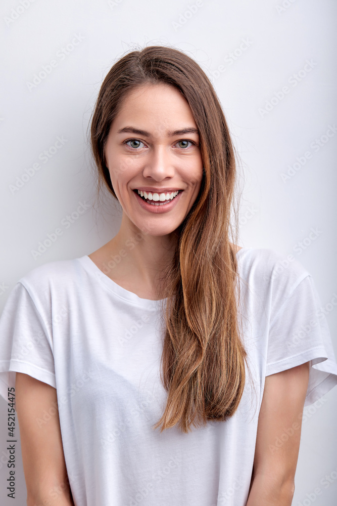Positive cheerful Female In Casual Outfit Looking At camera smiling cutely, isolated on white studio background, portrait of attractive lady with natural beauty, no make-up, posing alone. people Positive cheerful Female In Casual Outfit Looking At camera smiling cutely, isolated on white studio background, portrait of attractive lady with natural beauty, no make-up, posing alone. people