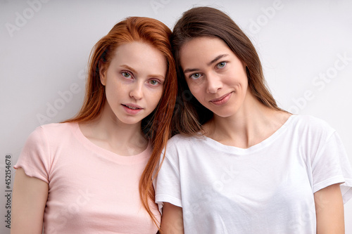 Two Confident Caucasian Ladies Lesbian Couple Posing Together Isolated On White Background, Female In Casual Wear Looking At Camera, Feeling Love, Close Relationships Of Women, Redhead ANd Brunette