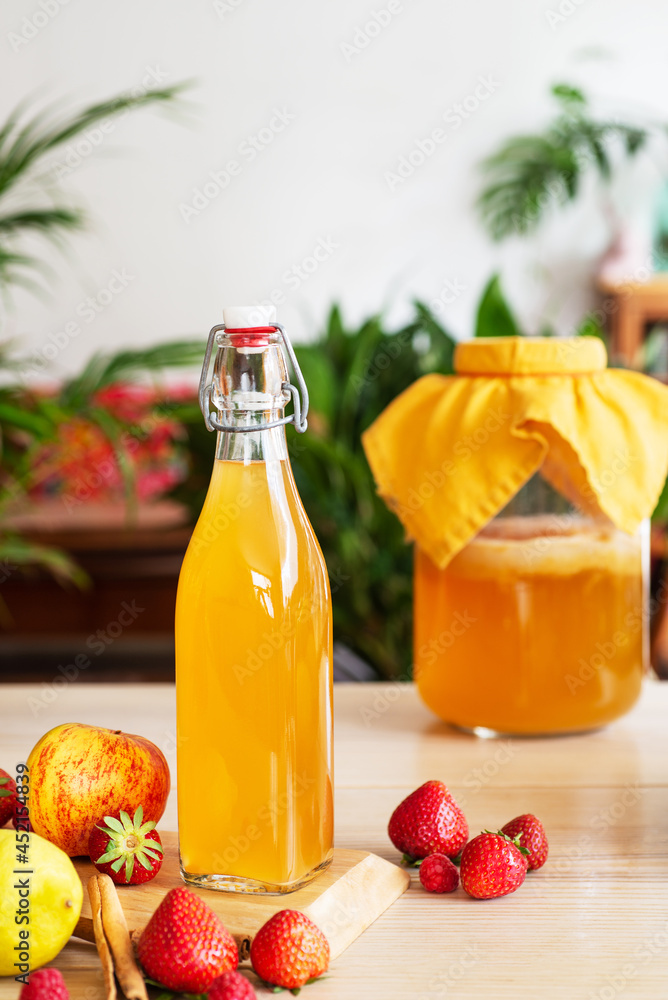 fermented drink, kombucha in glass bottle with with fruits and Berries fermented drink, kombucha in glass bottle with with fruits and Berries