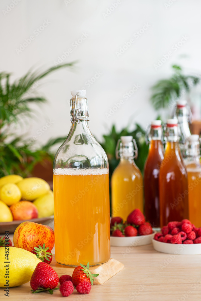 fermented drink, kombucha in glass bottle with with fruits and Berries fermented drink, kombucha in glass bottle with with fruits and Berries