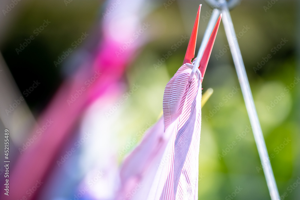 Drying laundry on the clothesline close up outdoors.