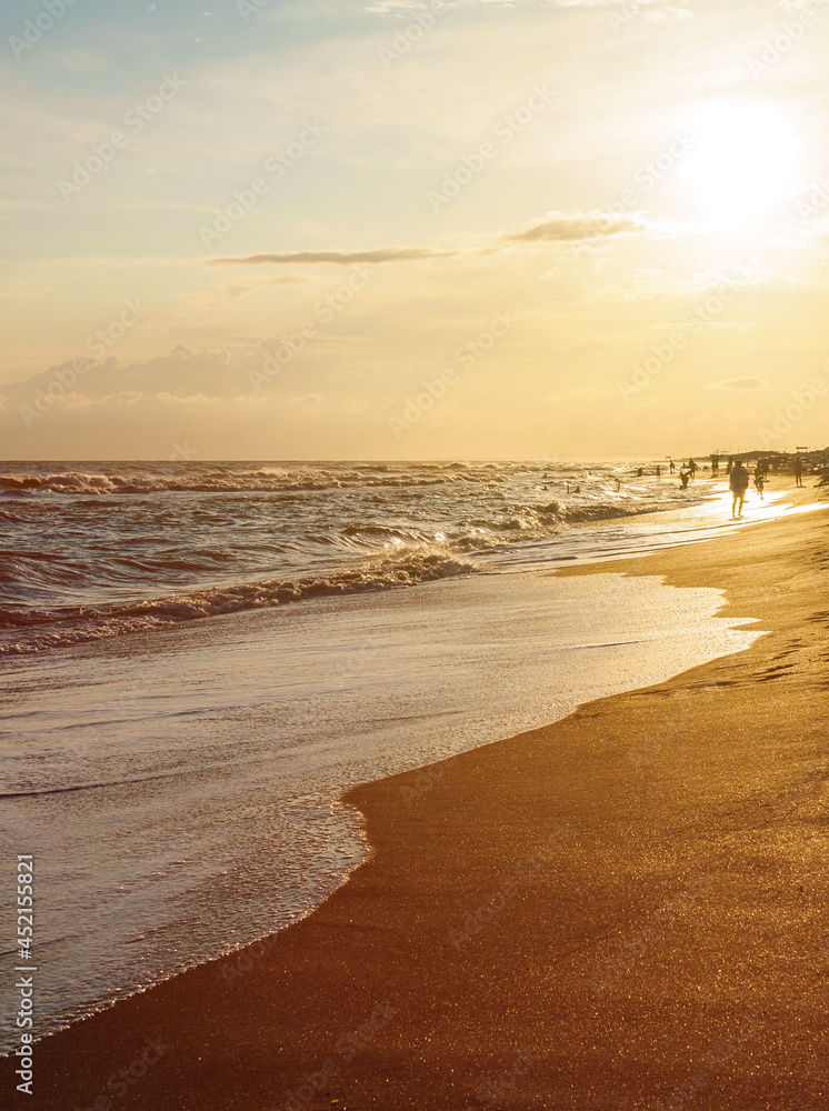 Beautiful seascape: sunset and beach with waves