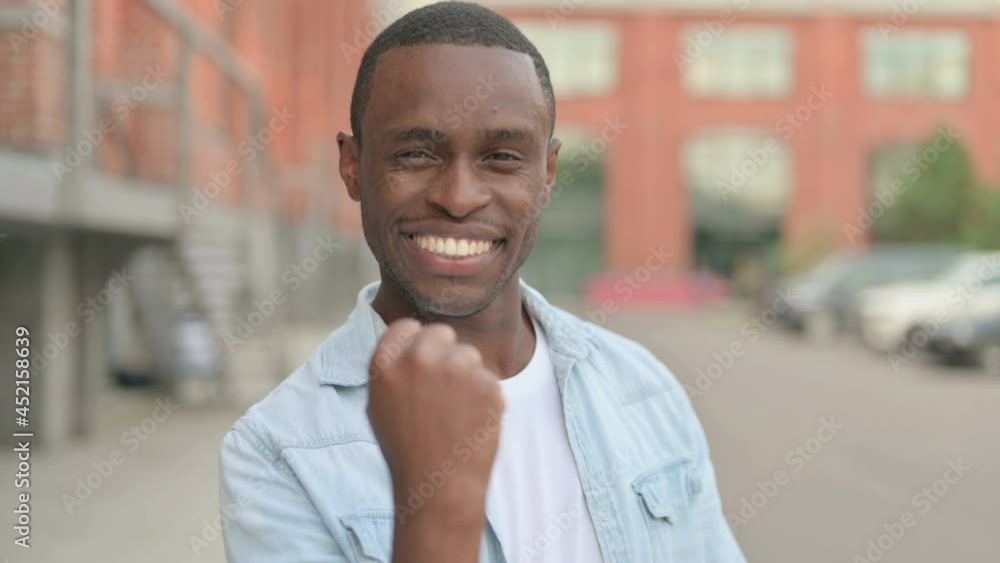 Outdoor Portrait of Excited African Man Celebrating Success Outdoor Portrait of Excited African Man Celebrating Success