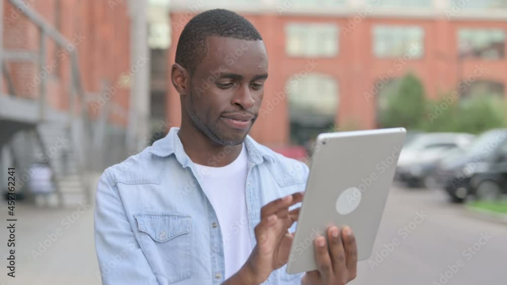 Portrait of African Man using Tablet in Street Portrait of African Man using Tablet in Street