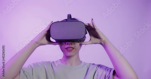 Asian girl puts on virtual reality glasses and begins to see in 5D attraction photo