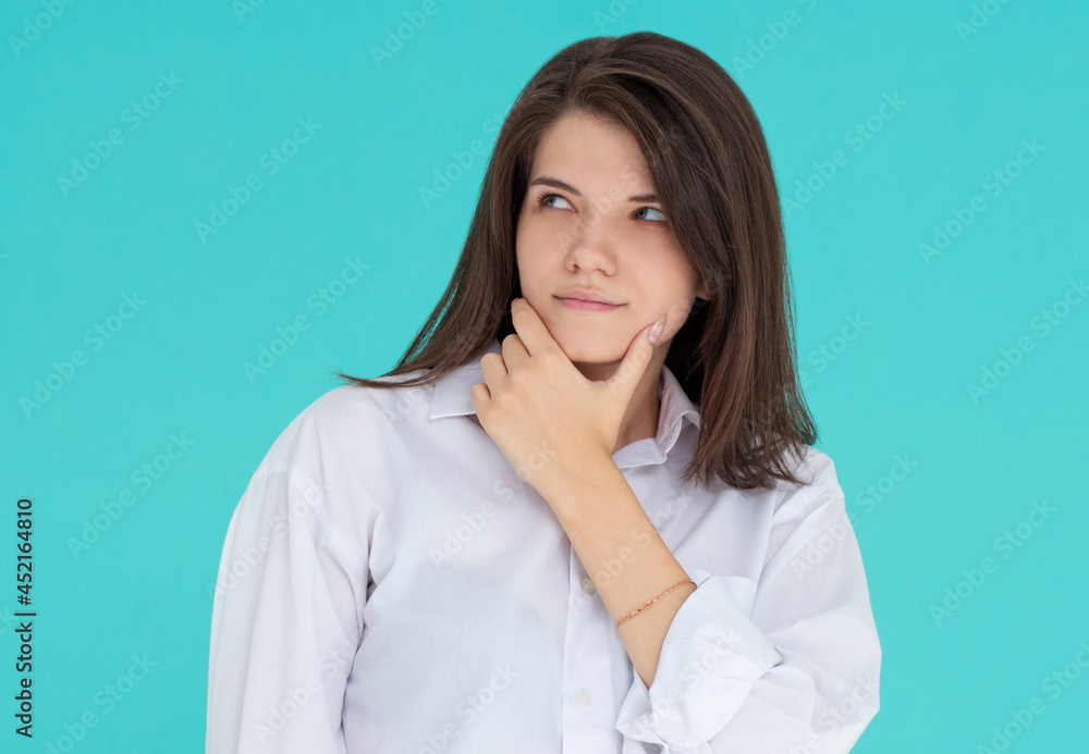 Thoughtful girl in studio. isolated blue backgroind Thoughtful girl in studio. isolated blue backgroind