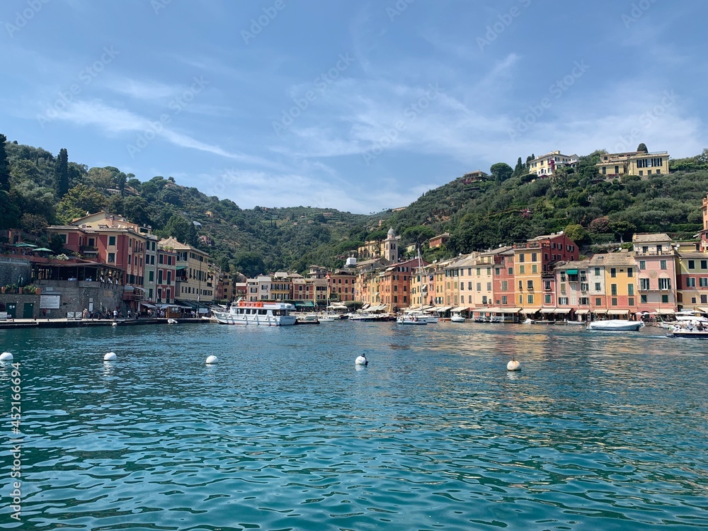 Skyline of Portofino village with colourful  houses and emerald water. It is famous holiday resort and fishing Italian riviera town. Portofino, Italy