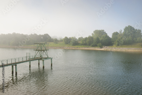 Old pier near the Oskara Kalpaka swing bridge over the canal, Liepaja, Latvia. National landmark, construction industry, architecture, history, navigation, transportation, nautical vessel concepts photo