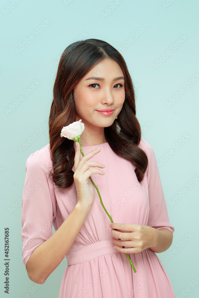woman smiling holding a rose holiday woman smiling holding a rose holiday