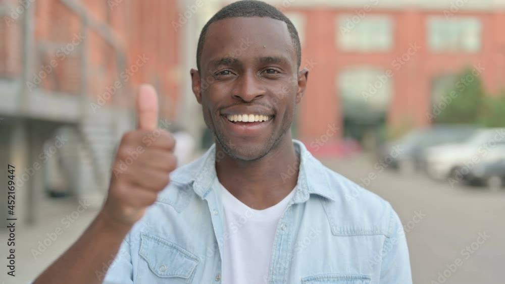 Portrait of African Man showing Thumbs Up Sign, Outdoor Portrait of African Man showing Thumbs Up Sign, Outdoor