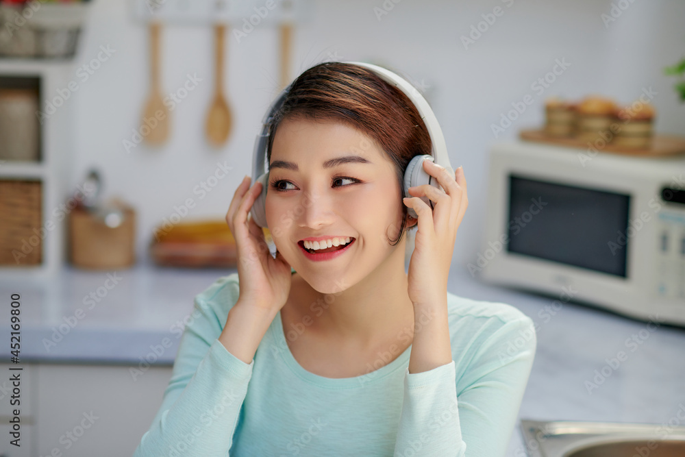 Young beautiful woman using enjoying music while healthy breakfast Young beautiful woman using enjoying music while healthy breakfast