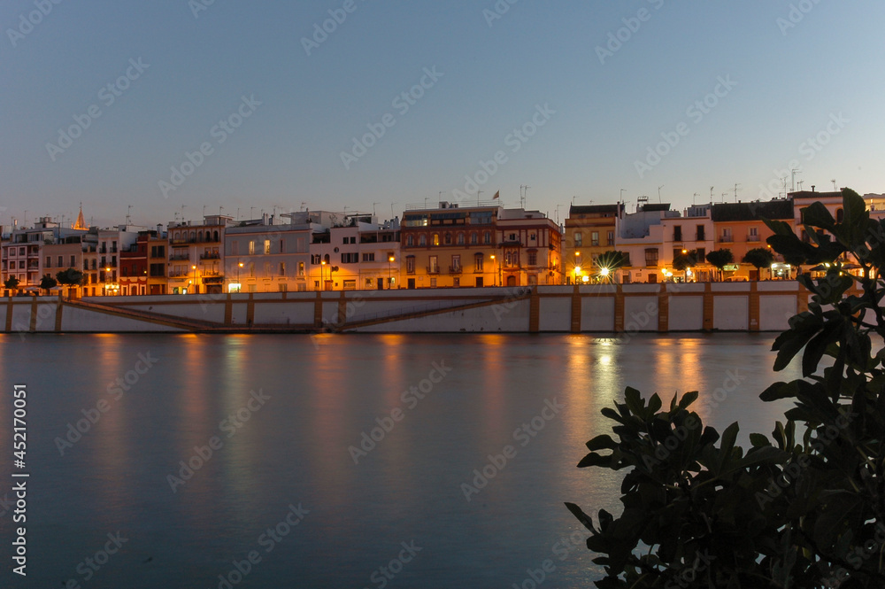 City lights reflecting in the river at night | Seville, Spain