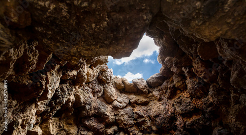 Tablou Canvas View of the sky from a cave, View from below of blue sky from a cave