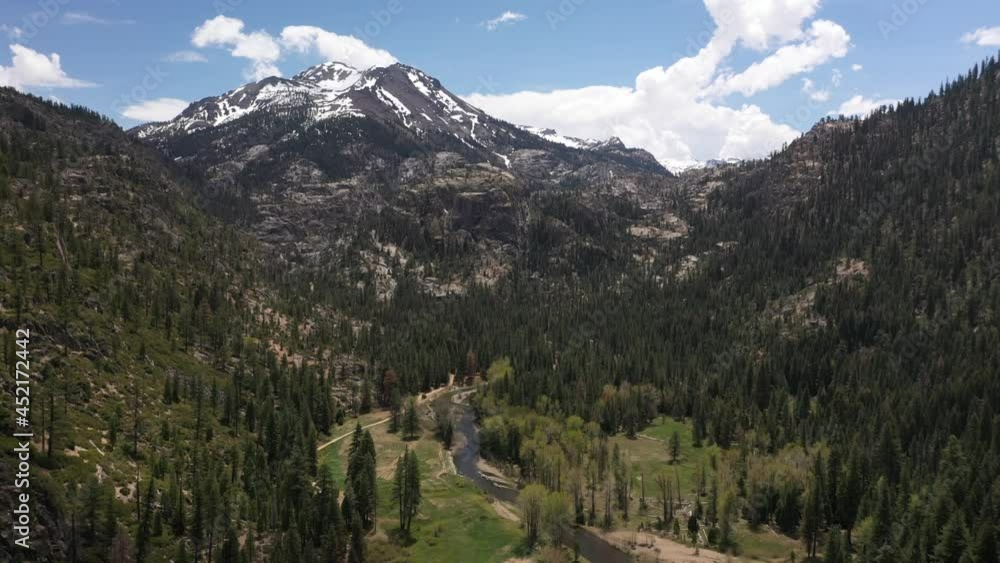 Sierra Stream Through Meadow With Snowy Peak Above - Aerial Sierra Stream Through Meadow With Snowy Peak Above - Aerial